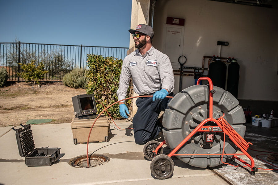 Plumber performing drain cleaning services