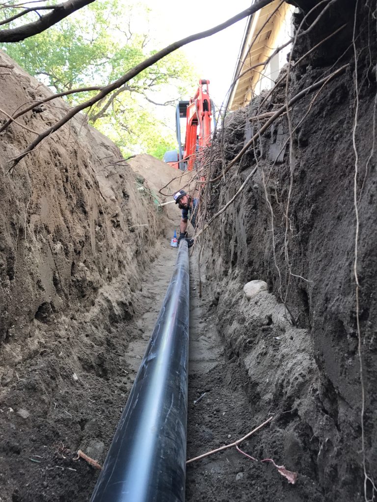 Plumber performing sewer line repair