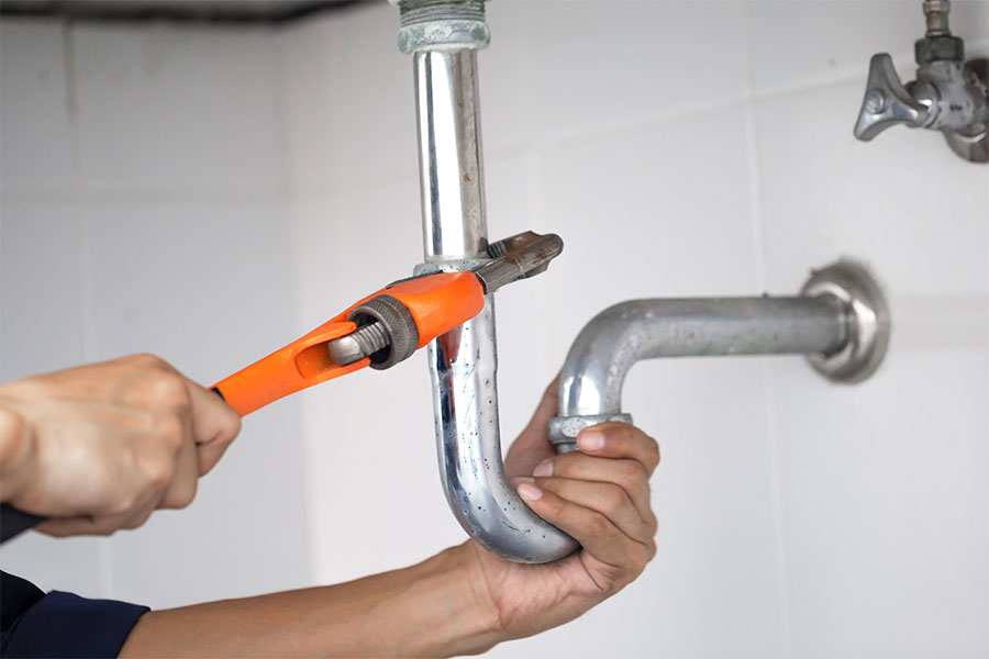 Professional plumber working on site