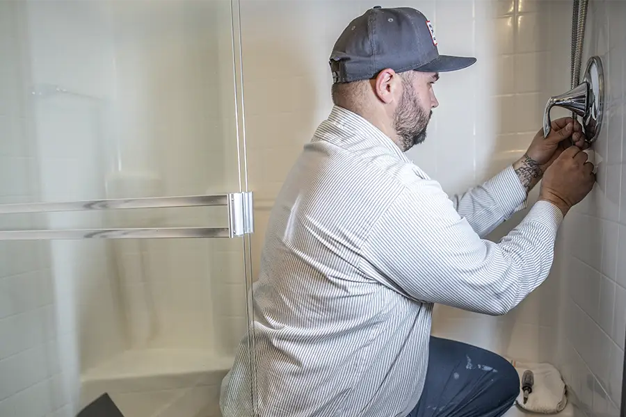 Plumber performing commercial restroom plumbing work