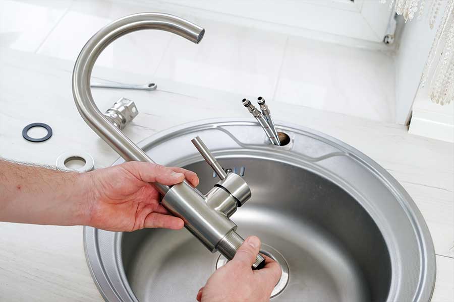 Plumber performing faucet installation