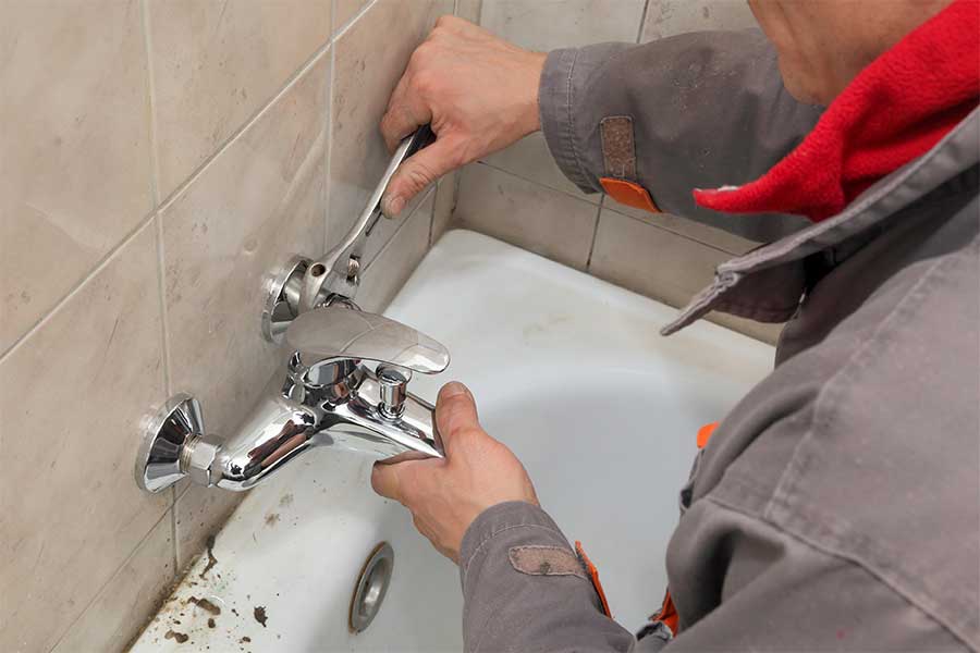 Professional faucet installation service in progress